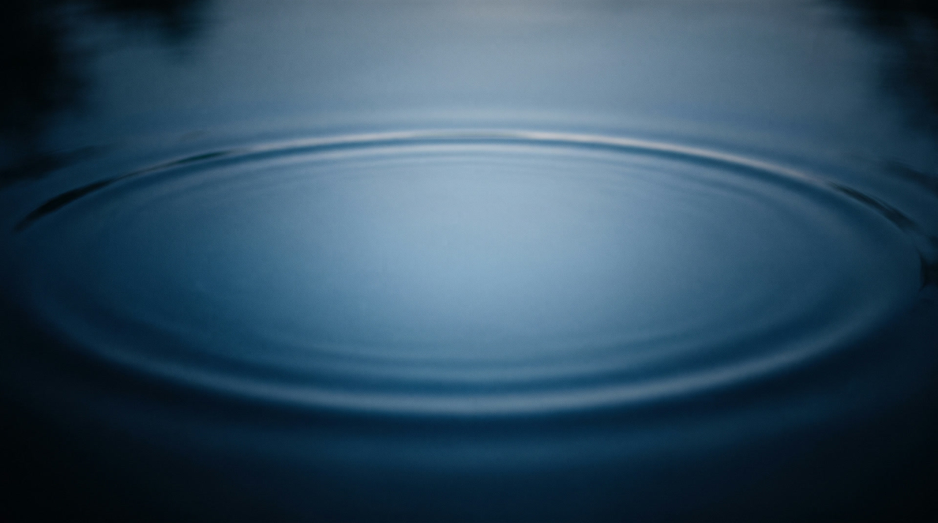 A wide faint outer ring dissolving at the edge of the light
